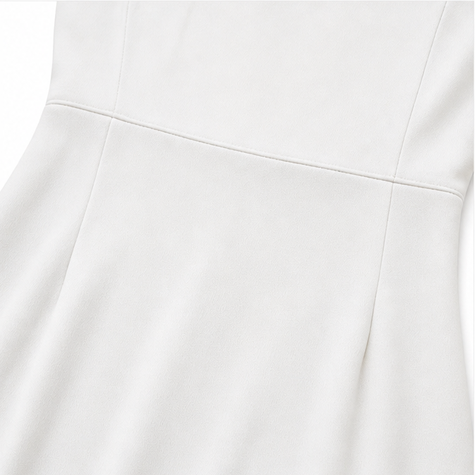 Close-up of the waist seam and panel stitching on an ivory pencil midi dress
