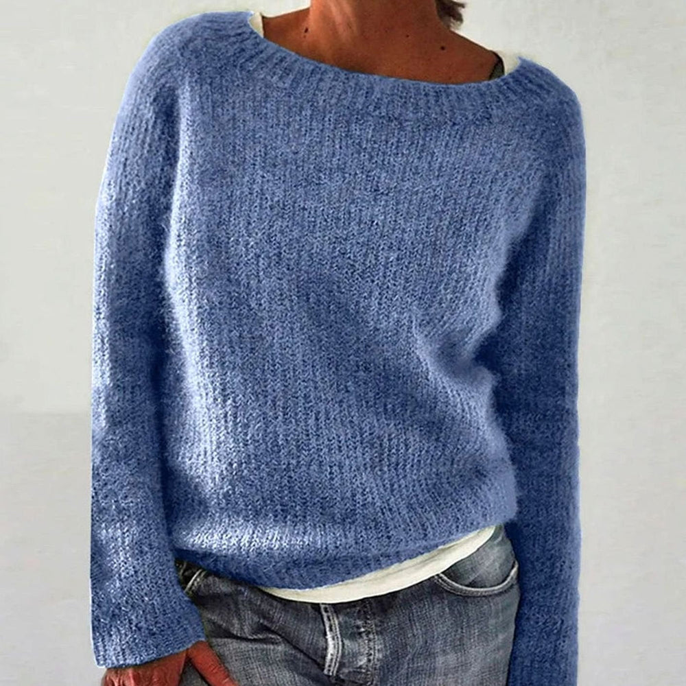 Dusty blue boat neck knit sweater with long sleeves, close front view over jeans