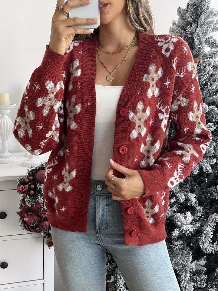 Rust red knit cardigan with gingerbread and snowflake motifs, worn open over a white top
