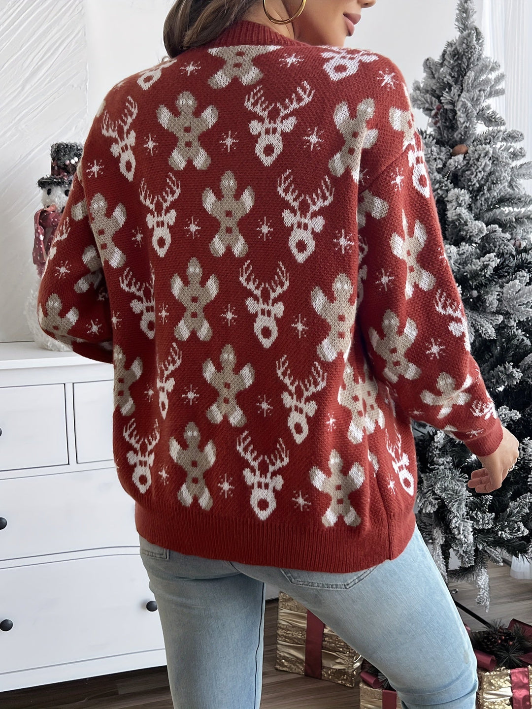 Back view of a red knit sweater with cream gingerbread, reindeer and snowflake motifs