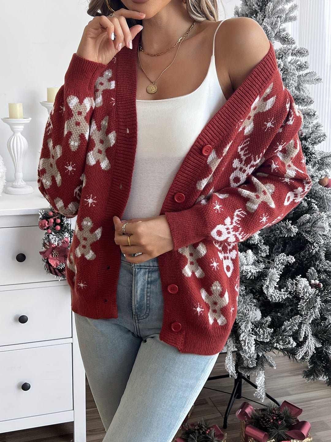 Red knit button cardigan with gingerbread men, reindeer and snowflakes, worn open