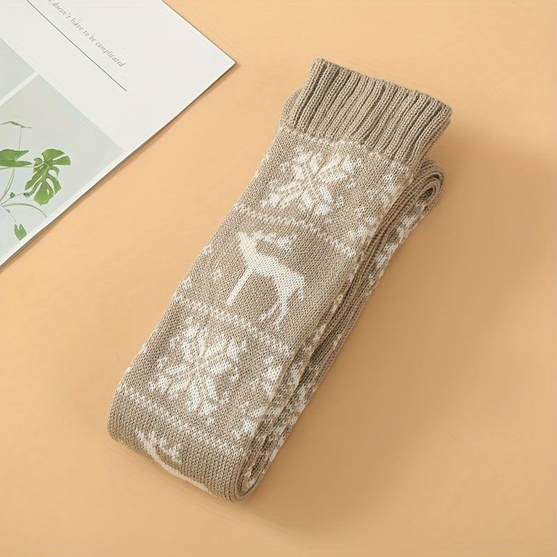 Folded beige knit knee high socks with white reindeer and snowflake motifs