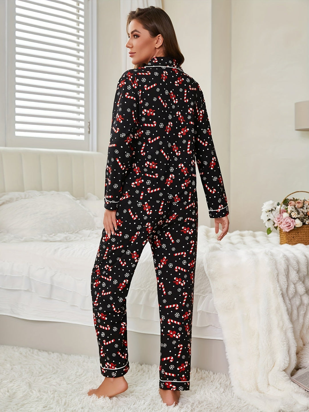 Back view of a black pajama set with candy cane and snowflake print and white piping
