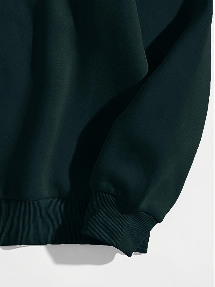 Close up of the ribbed hem and cuff on a dark green sweatshirt