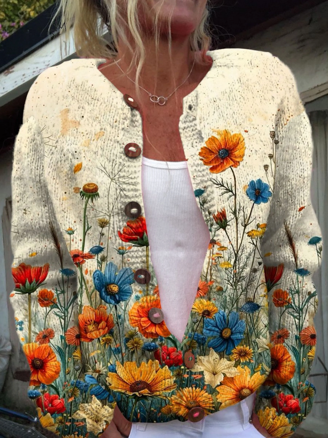 Cream knit cardigan with a colorful wildflower print, worn over a white top