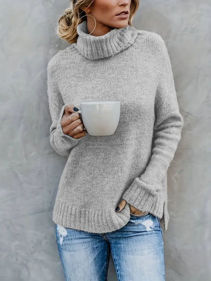 Grey turtleneck sweater with wide folded cuffs and side slits, front view