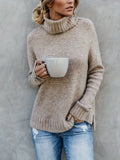 Oatmeal turtleneck sweater with folded cuffs worn over blue jeans, front view