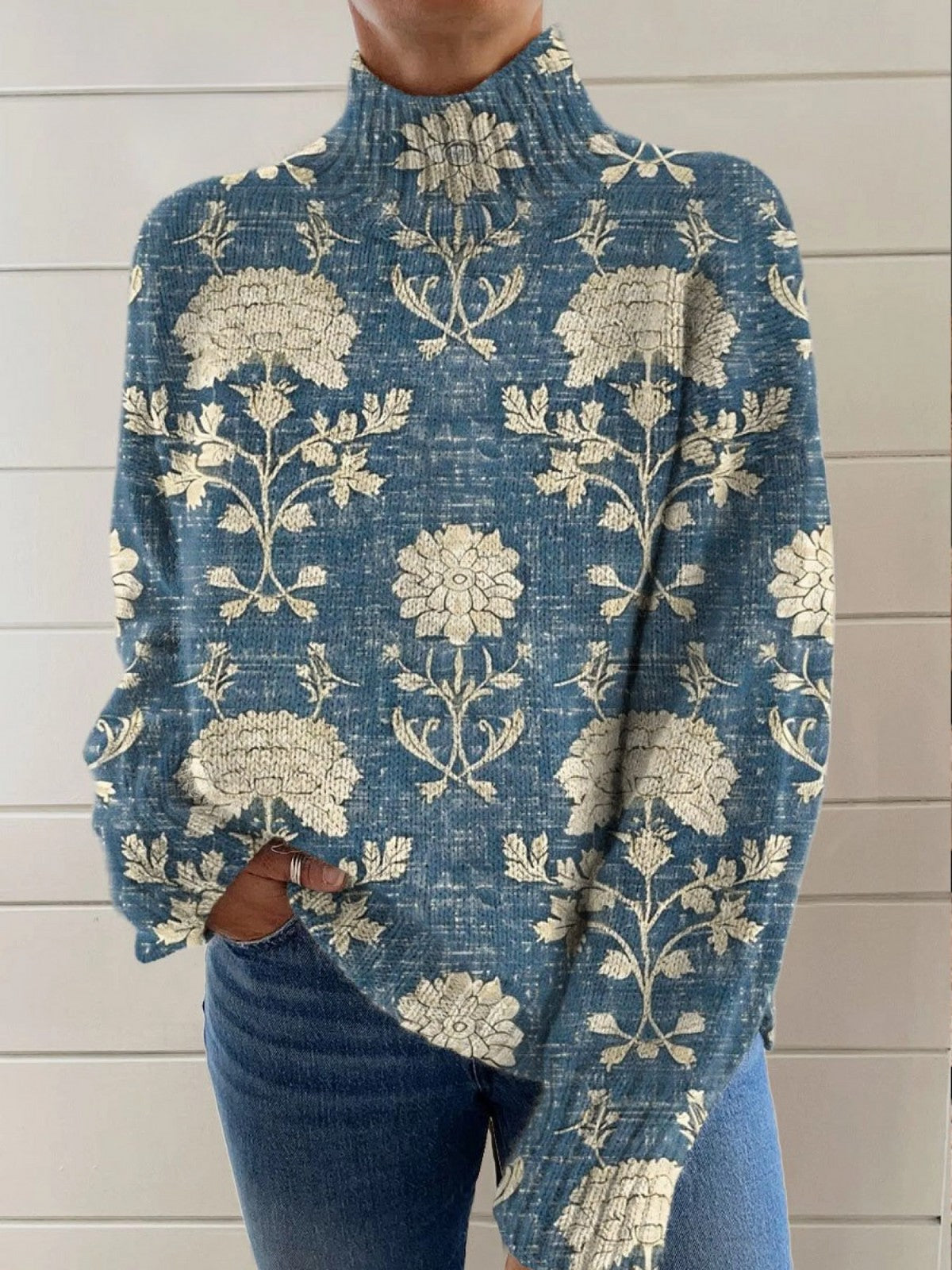 Blue mock neck sweater with a cream folk flower repeat print