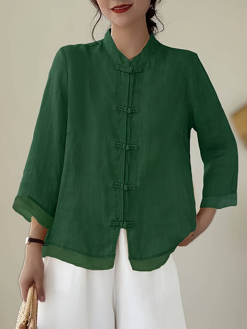 Green linen blouse with knotted frog closures and a mandarin collar