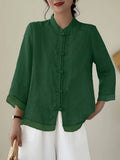 Green linen blouse with knotted frog closures and a mandarin collar
