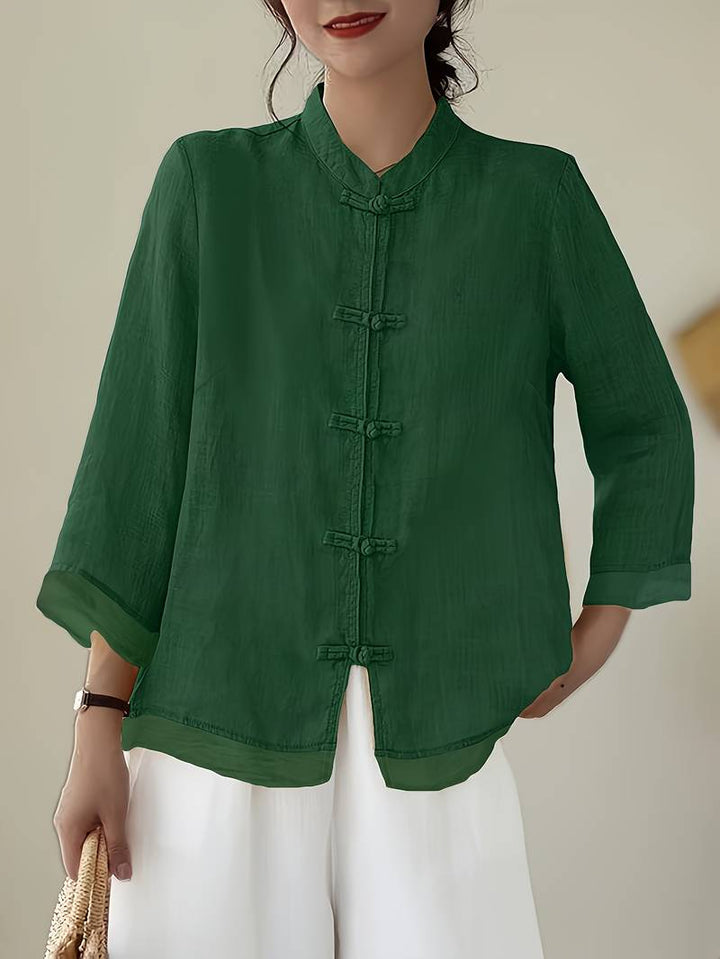 Green linen blouse with knotted frog closures and a mandarin collar