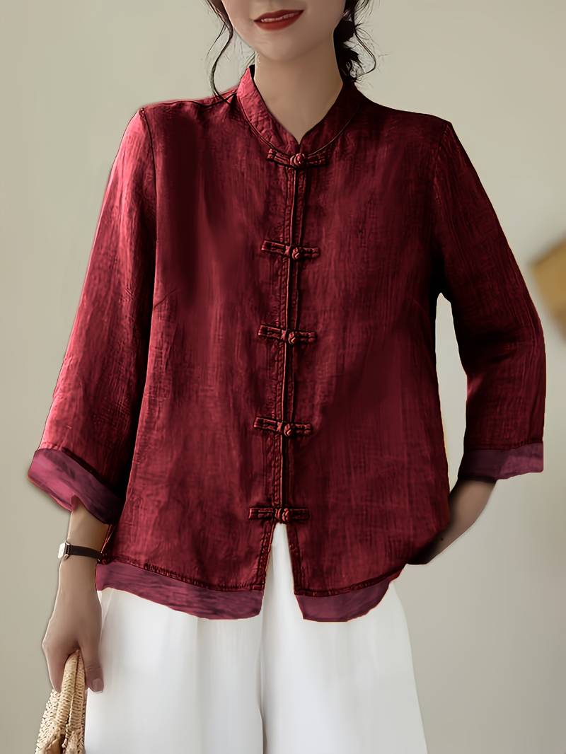 Red linen blouse with knotted frog closures and a curved hem