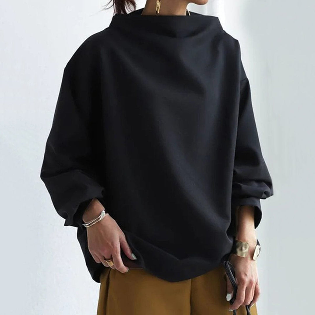 Black funnel neck dolman top showing the boxy body and dropped sleeve