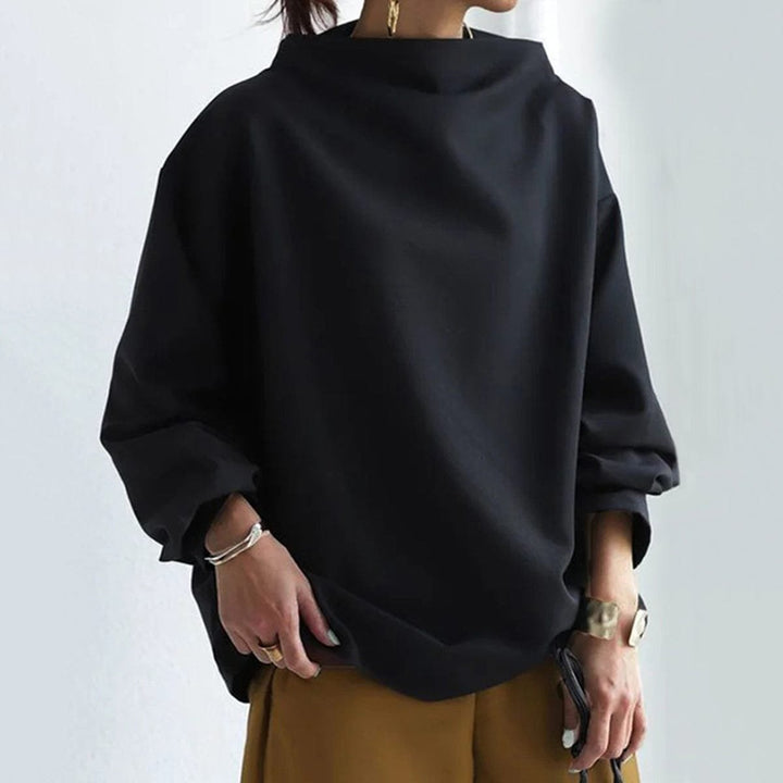 Black funnel neck dolman top showing the boxy body and dropped sleeve