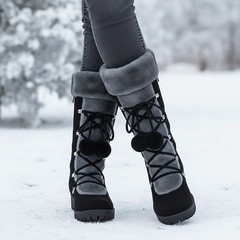 Close view of the black fur cuff boots worn in deep snow