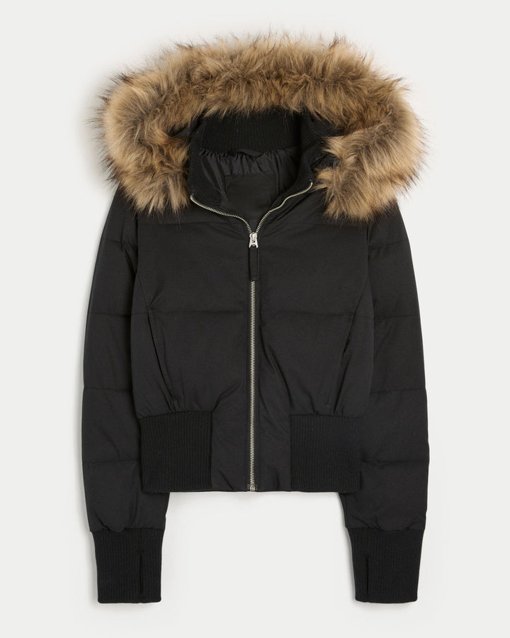 Black cropped puffer jacket laid flat with ribbed waistband and cuffs