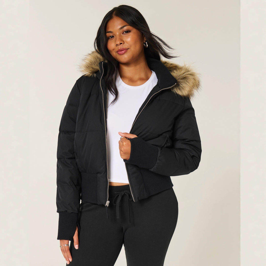 Black cropped puffer jacket with a faux fur trimmed hood, front view