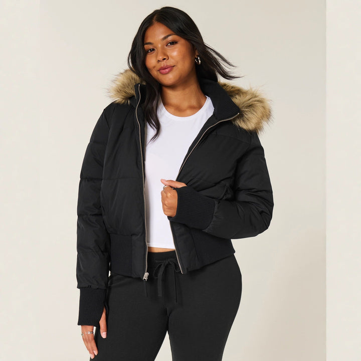 Black cropped puffer jacket with a faux fur trimmed hood, front view