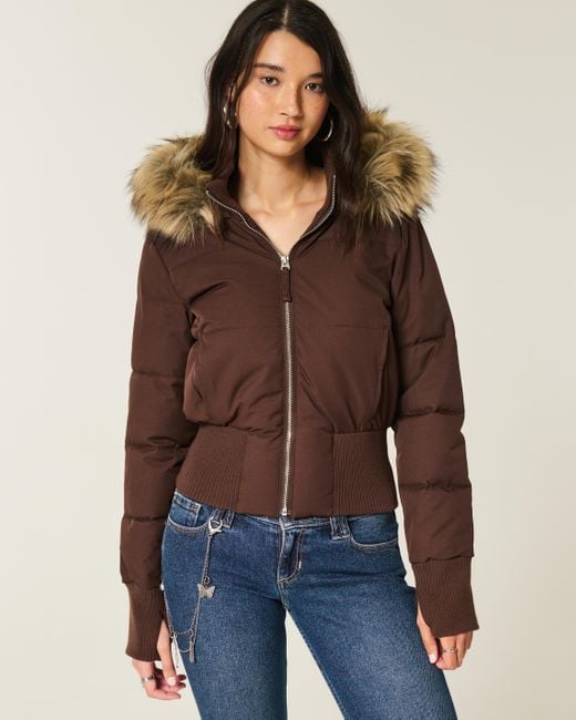 Brown cropped puffer jacket with a faux fur trimmed hood, front view