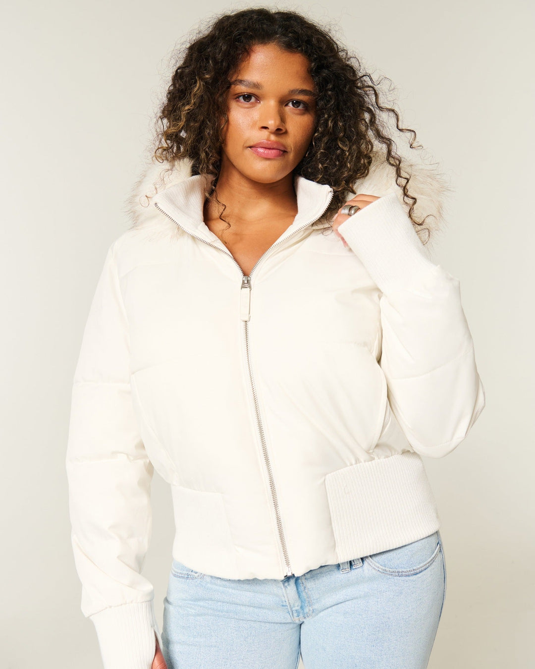 Cream cropped puffer jacket with a faux fur trimmed hood, front view