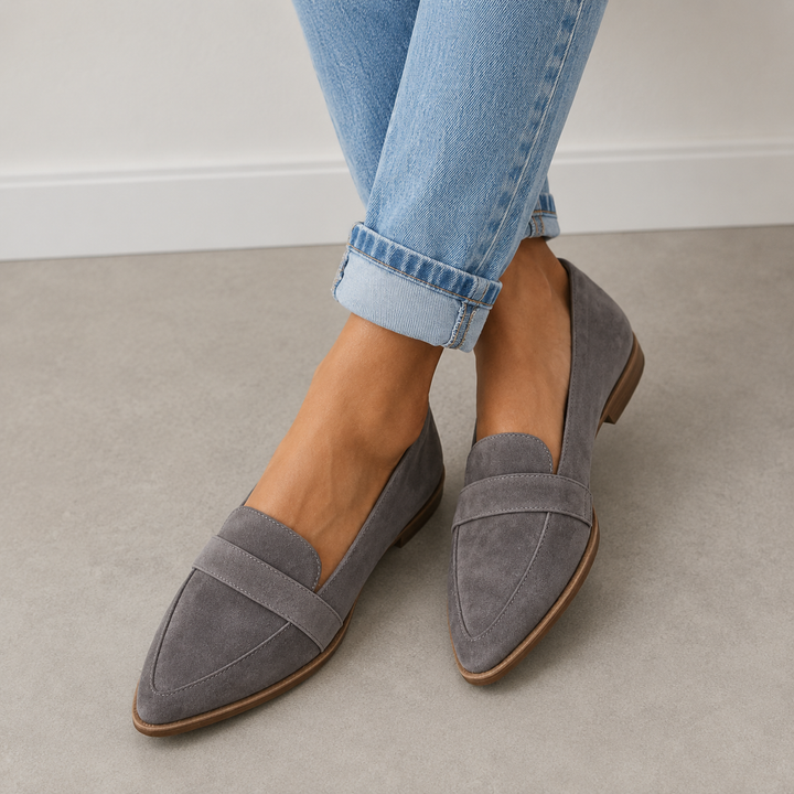 Grey suede pointed toe loafers worn with cropped jeans