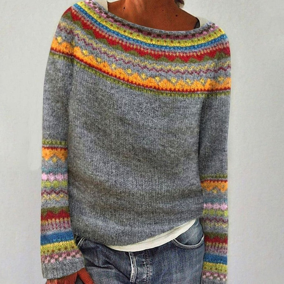 Grey knit sweater with multicolor fair isle yoke and cuffs, worn with jeans