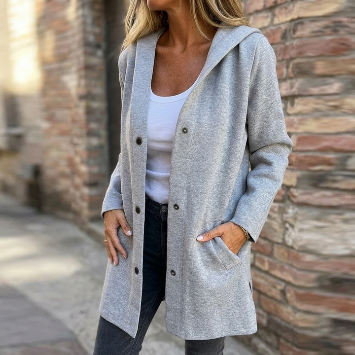 Woman wearing a grey hooded longline cardigan jacket with front pockets