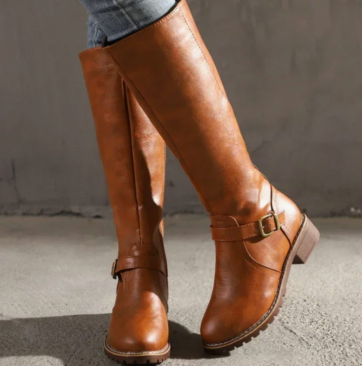 Tan knee high leather boots with buckle straps and block heels
