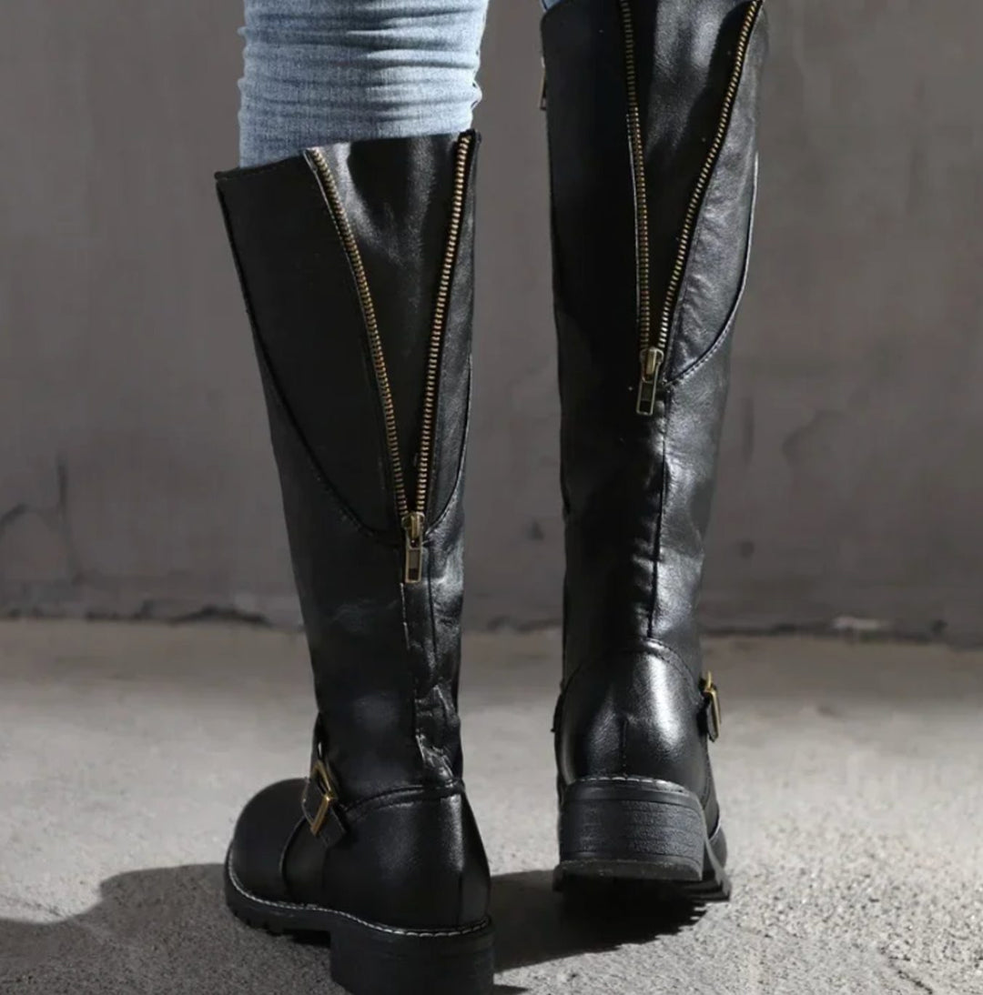 Back view of black knee high boots with gold side zip and buckle strap