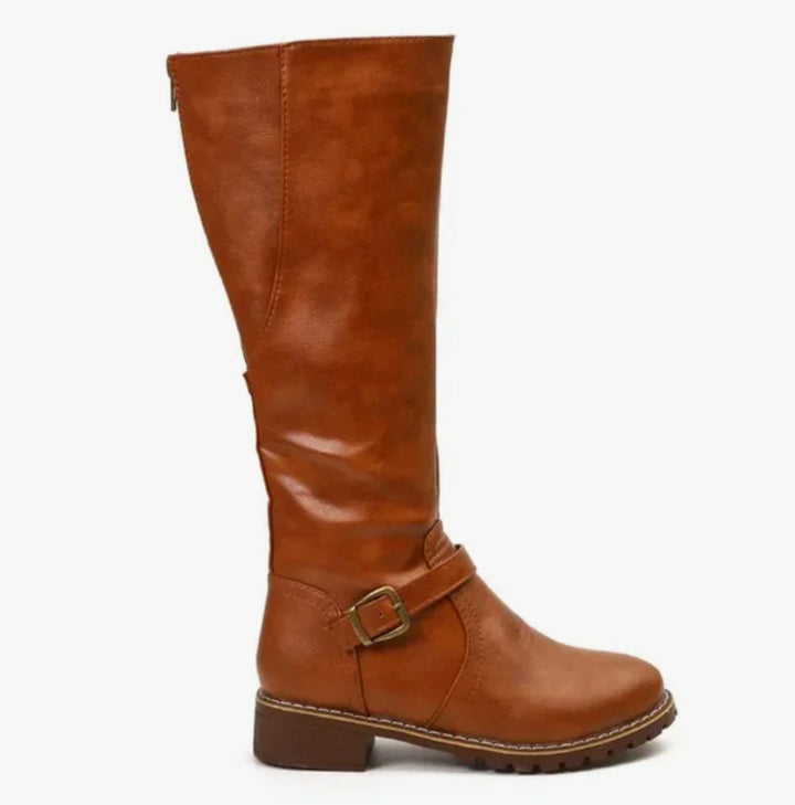 Tan knee high riding boot with buckle strap and low block heel, side view