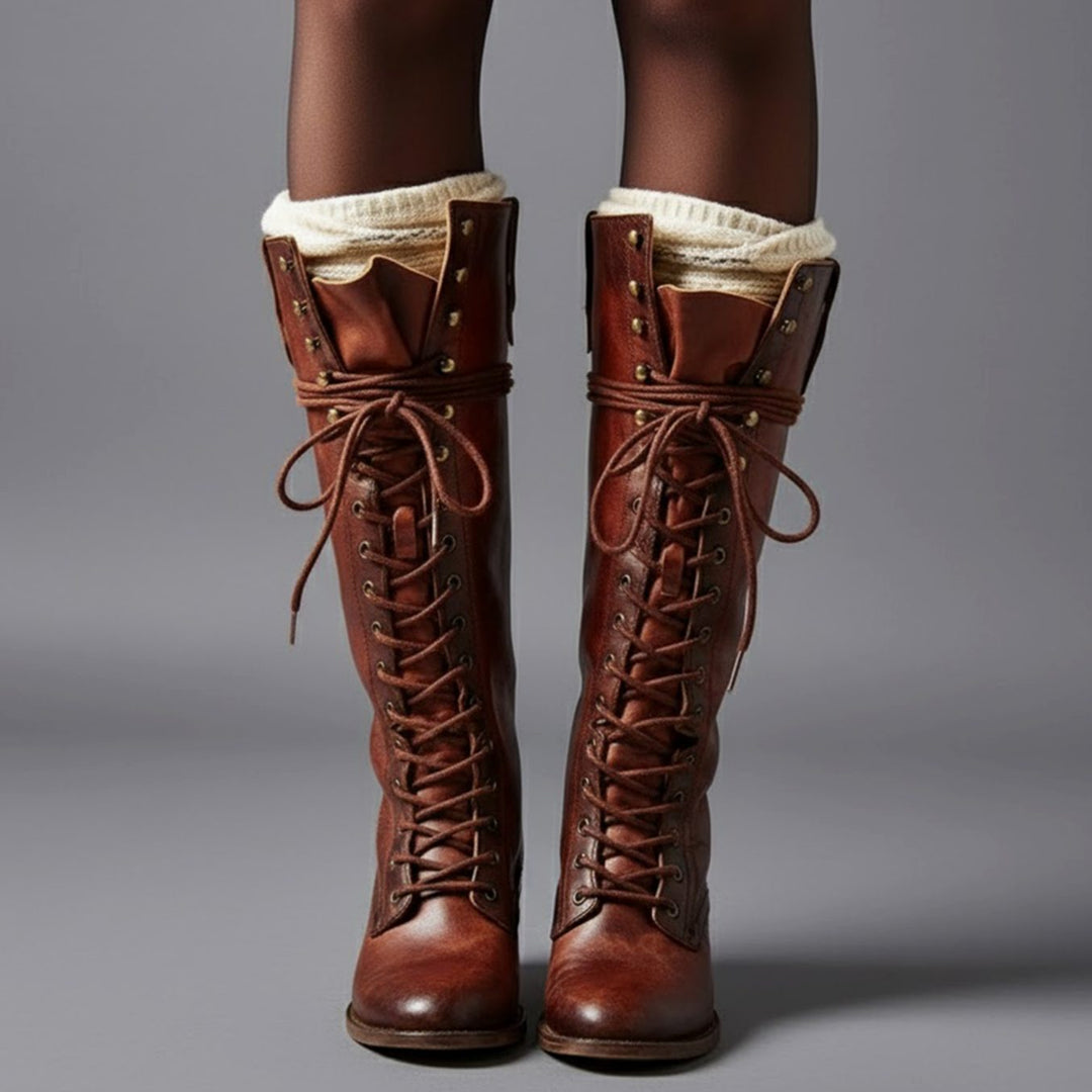 Brown lace up knee high boots with a studded shaft, worn with cream boot socks