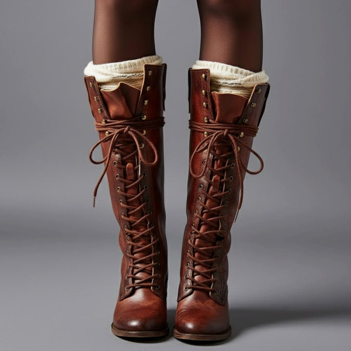Brown lace up knee high boots with a studded shaft, worn with cream boot socks