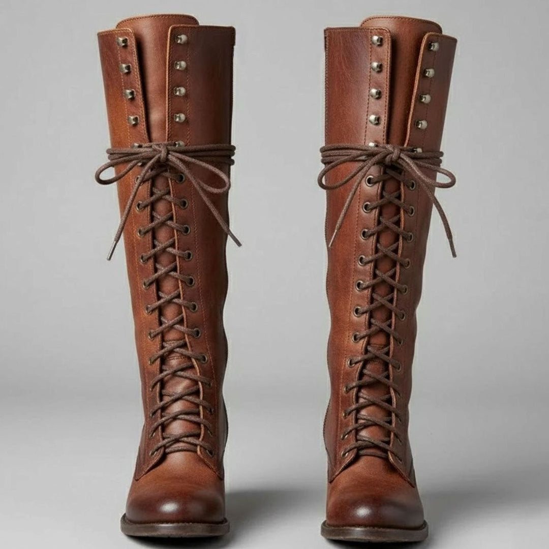Pair of brown leather lace up knee high boots with studded shafts, front view