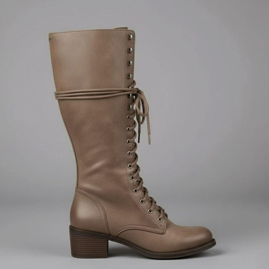 Taupe lace up knee high boot with a studded shaft and stacked block heel, side view