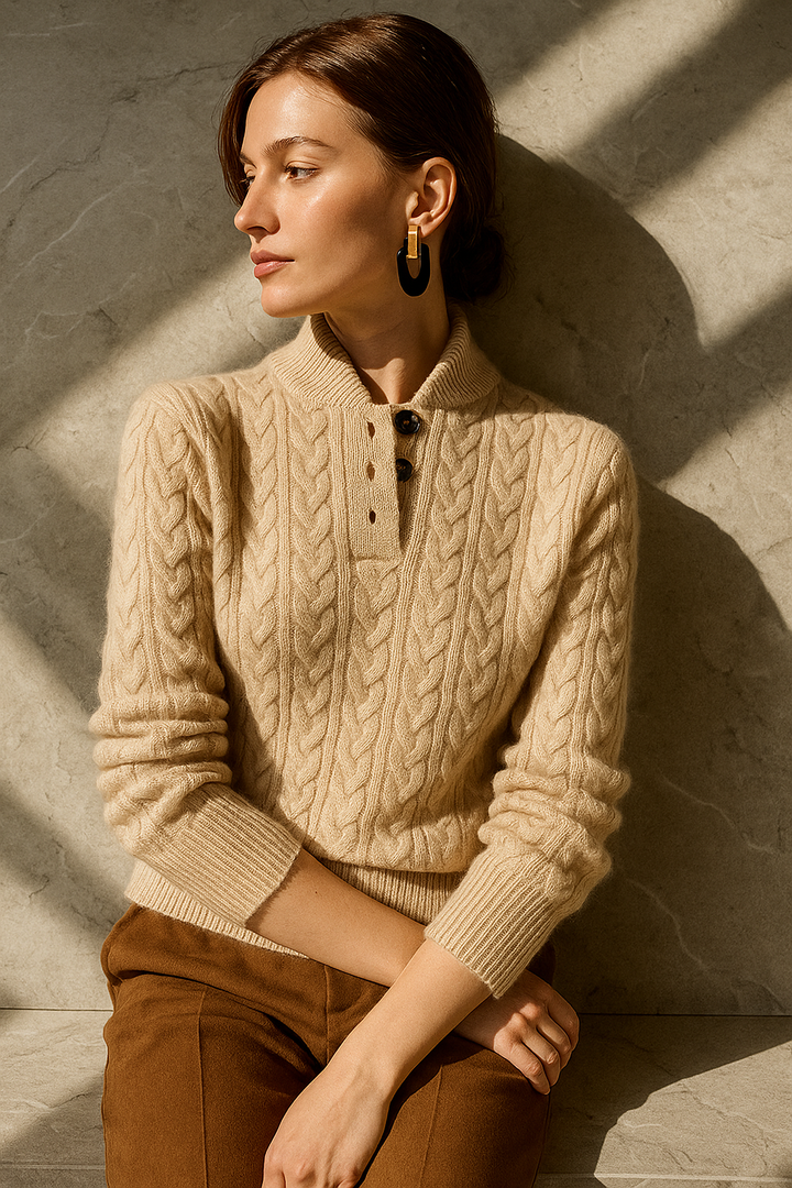 Khaki cable knit sweater with a stand collar, worn seated in daylight, side angle