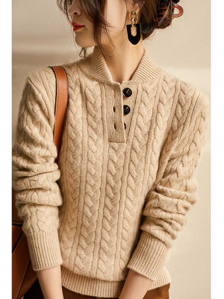 Khaki cable knit sweater with a stand collar, worn with a bag strap across the chest
