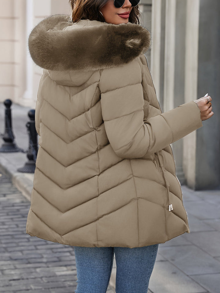 Khaki quilted coat seen from the side with the fur hood up