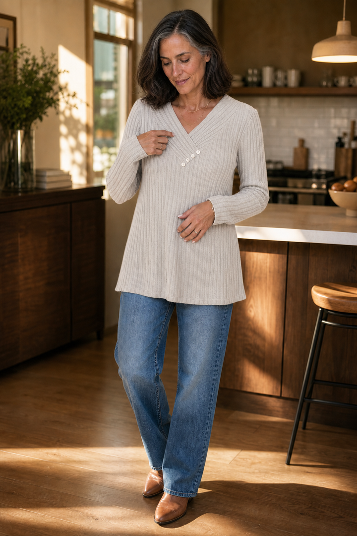 Woman wearing an oatmeal ribbed V neck button sweater with straight leg jeans