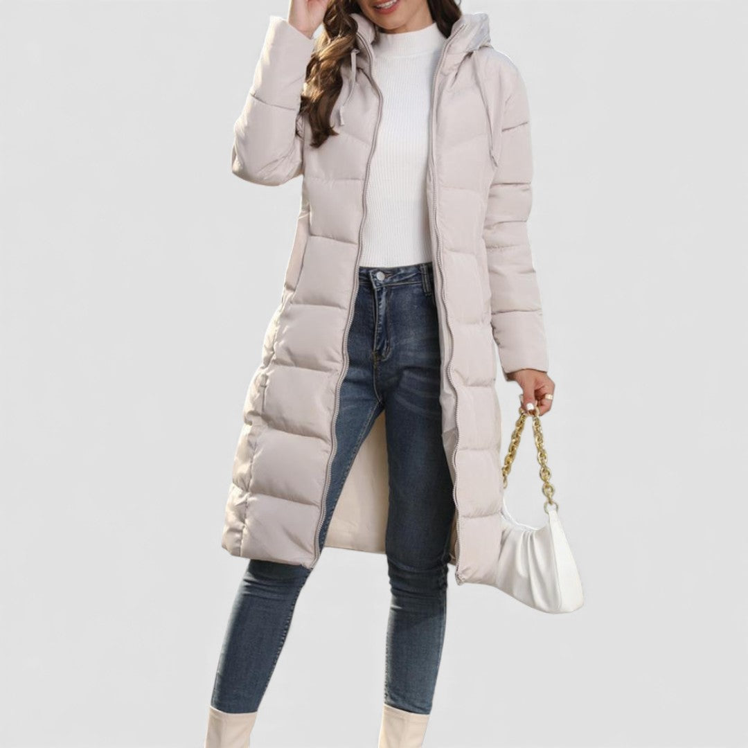 Model wearing the beige long hooded puffer coat open over jeans