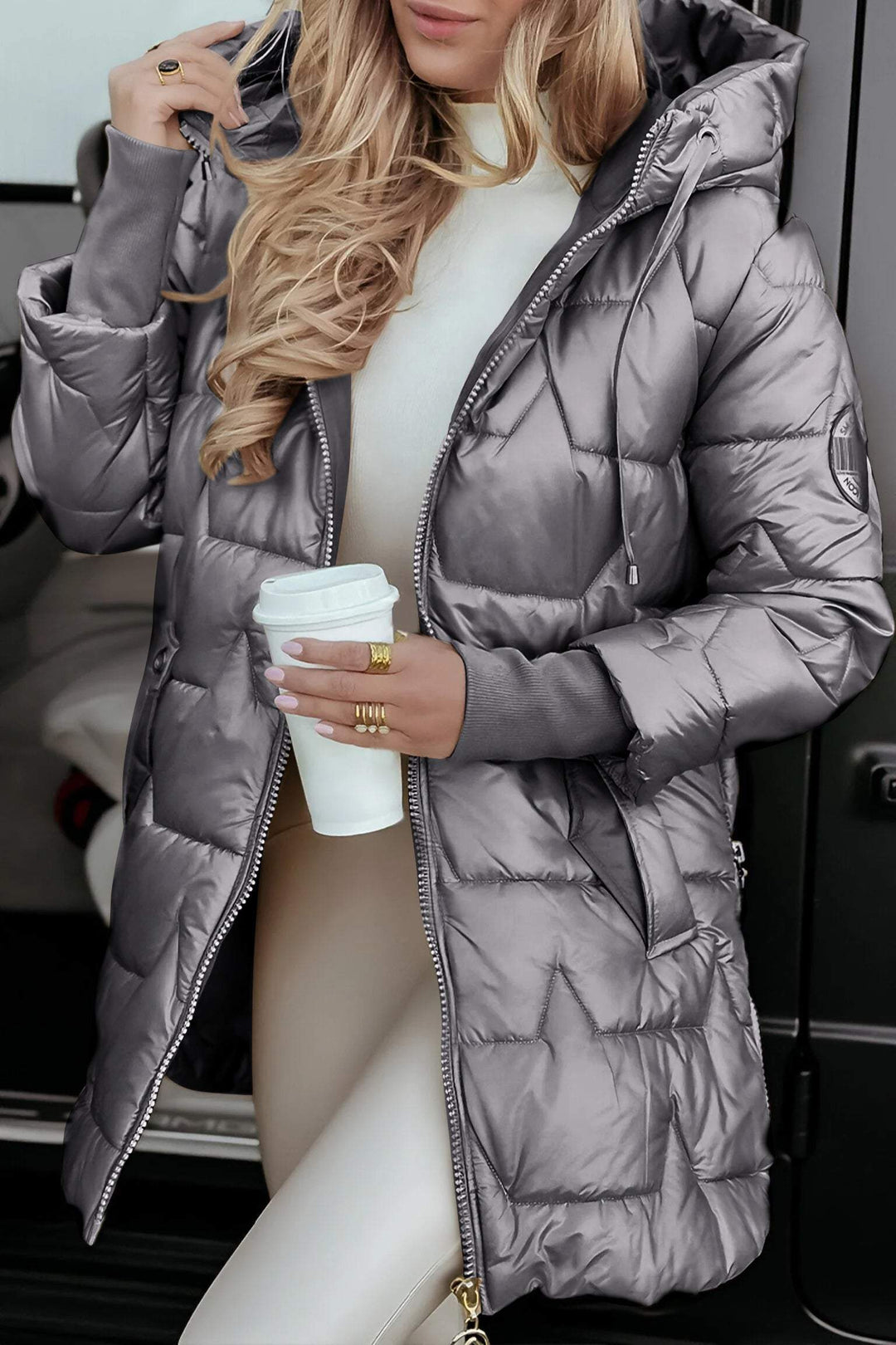 Grey glossy longline puffer coat with chevron quilting, front view