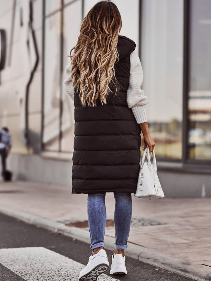 Black longline hooded puffer vest showing the knee length hem, back view