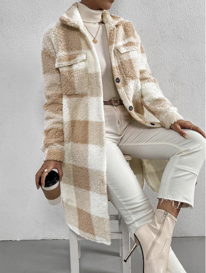 Camel and cream teddy check coat over white jeans, seated view