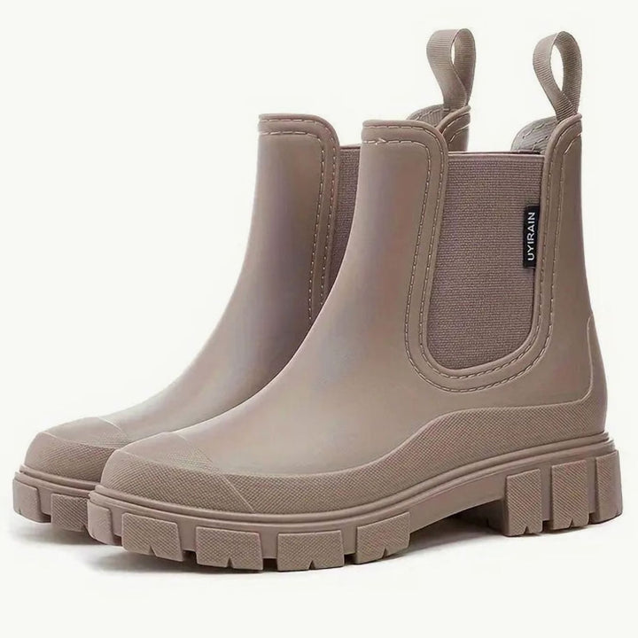 Taupe waterproof chelsea rain boots with chunky lug sole, angled pair view