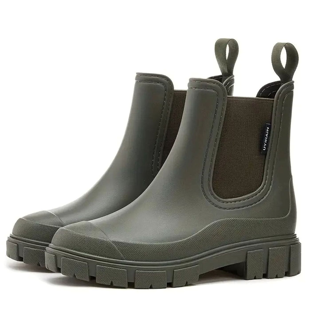 Pair of olive green waterproof Chelsea rain boots with lug soles