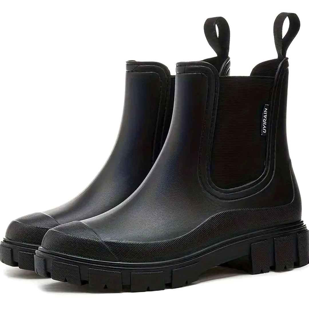 Pair of black waterproof Chelsea rain boots with lug soles
