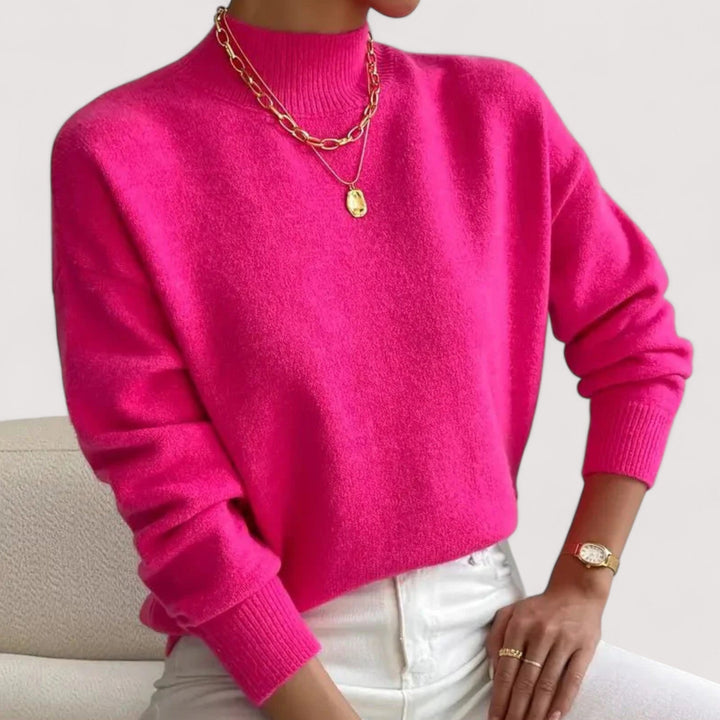 Hot pink loose fit knit sweater with mock neck and ribbed cuffs, front view