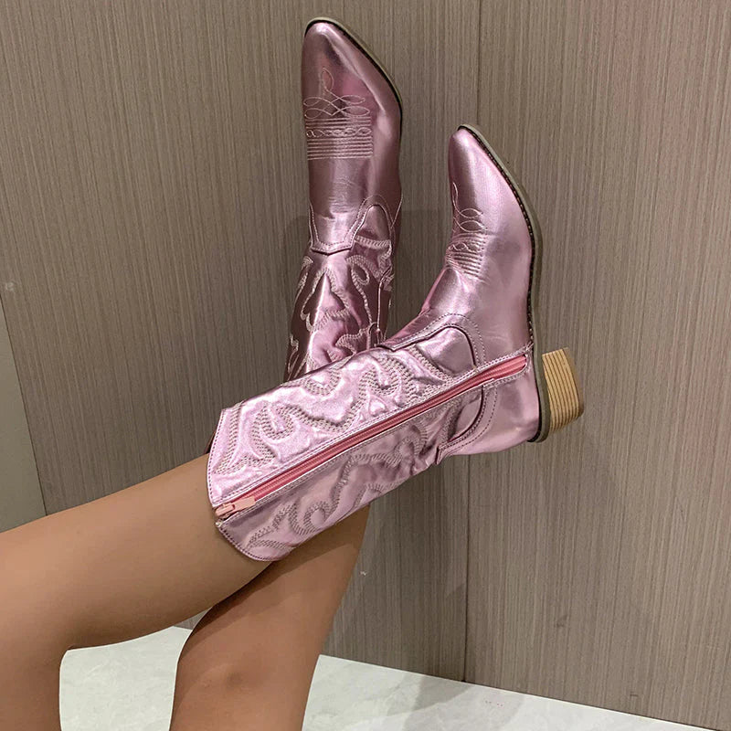 Pink metallic western boot with a side zip, raised leg view