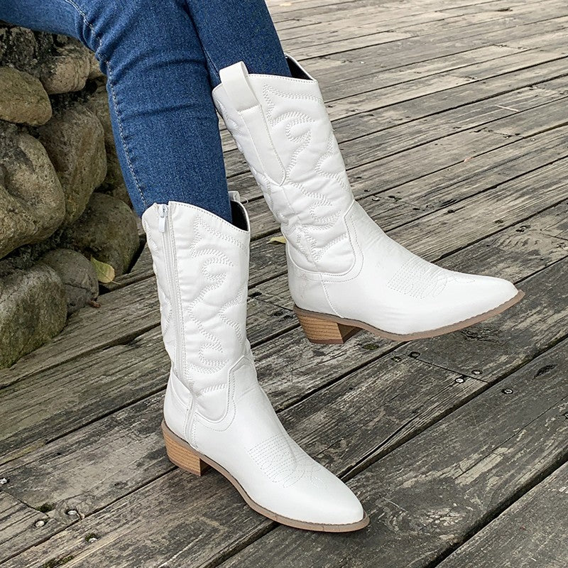 White western knee boots with embroidered shafts worn with jeans