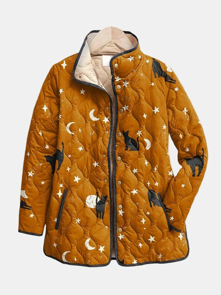Mustard quilted jacket with a black cat, moon and star print and a stand collar