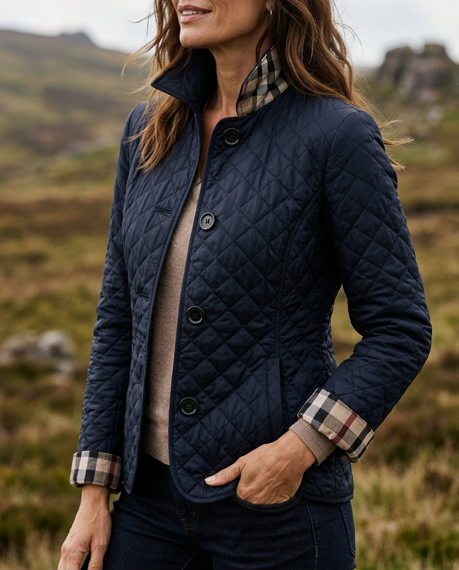Navy diamond quilted jacket with check lined cuffs turned back